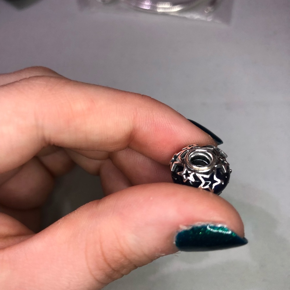 Sapphire blue charm. New in the bag. Never worn. Hint of stars around the edges